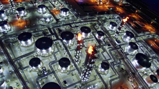 Aerial view of oilfield infrastructure and processing facilities at night